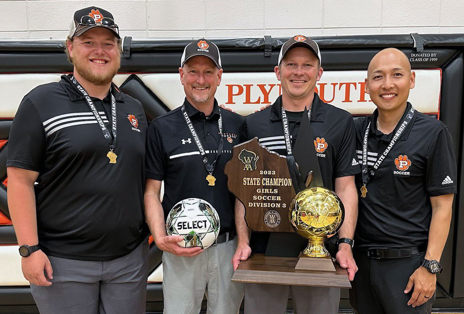 coaches with trophy