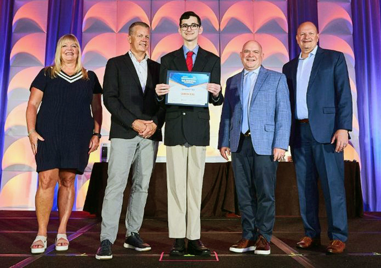 student receiving Microsoft award on stage