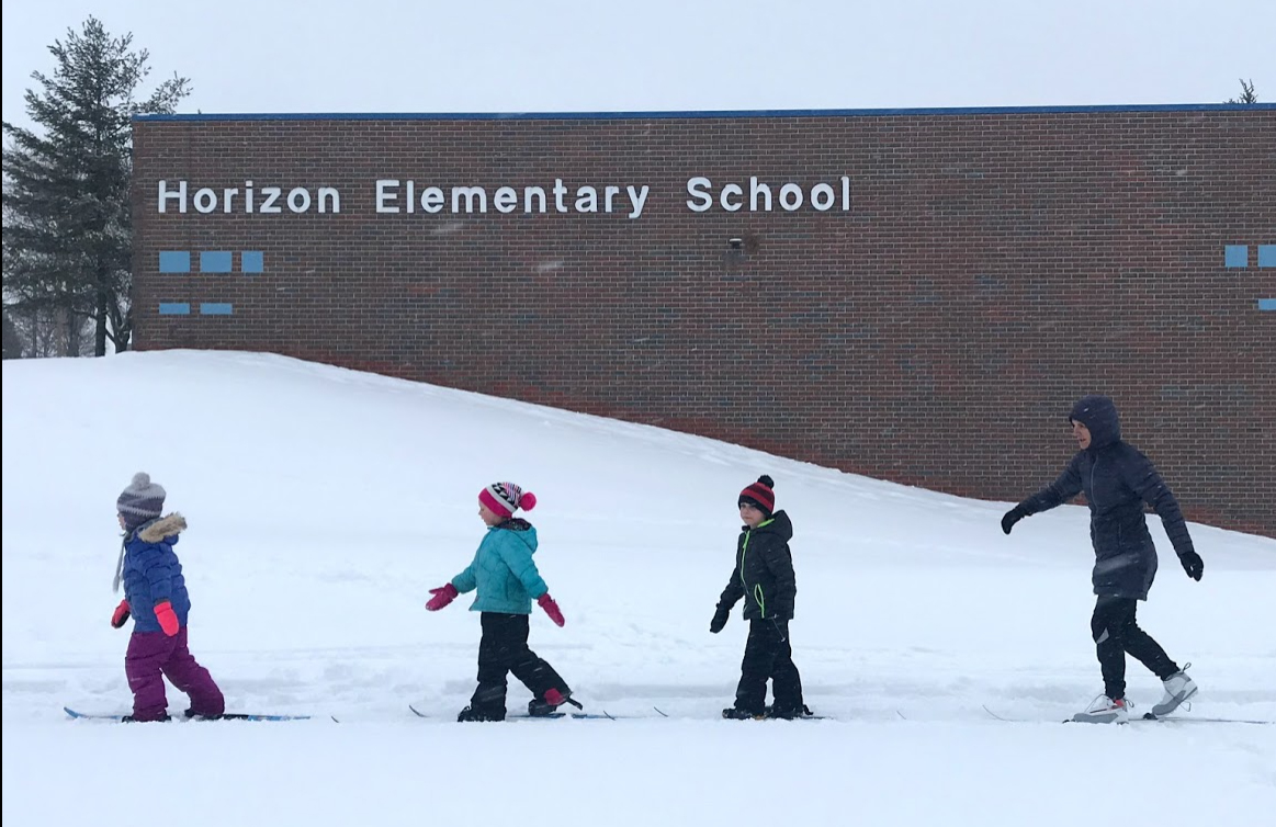students skiing outside horizon